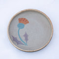 Ceramic plate with a floral design on a white background