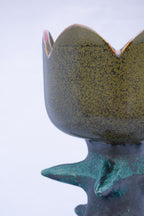 Ceramic lamp with textured surface on a light gray background