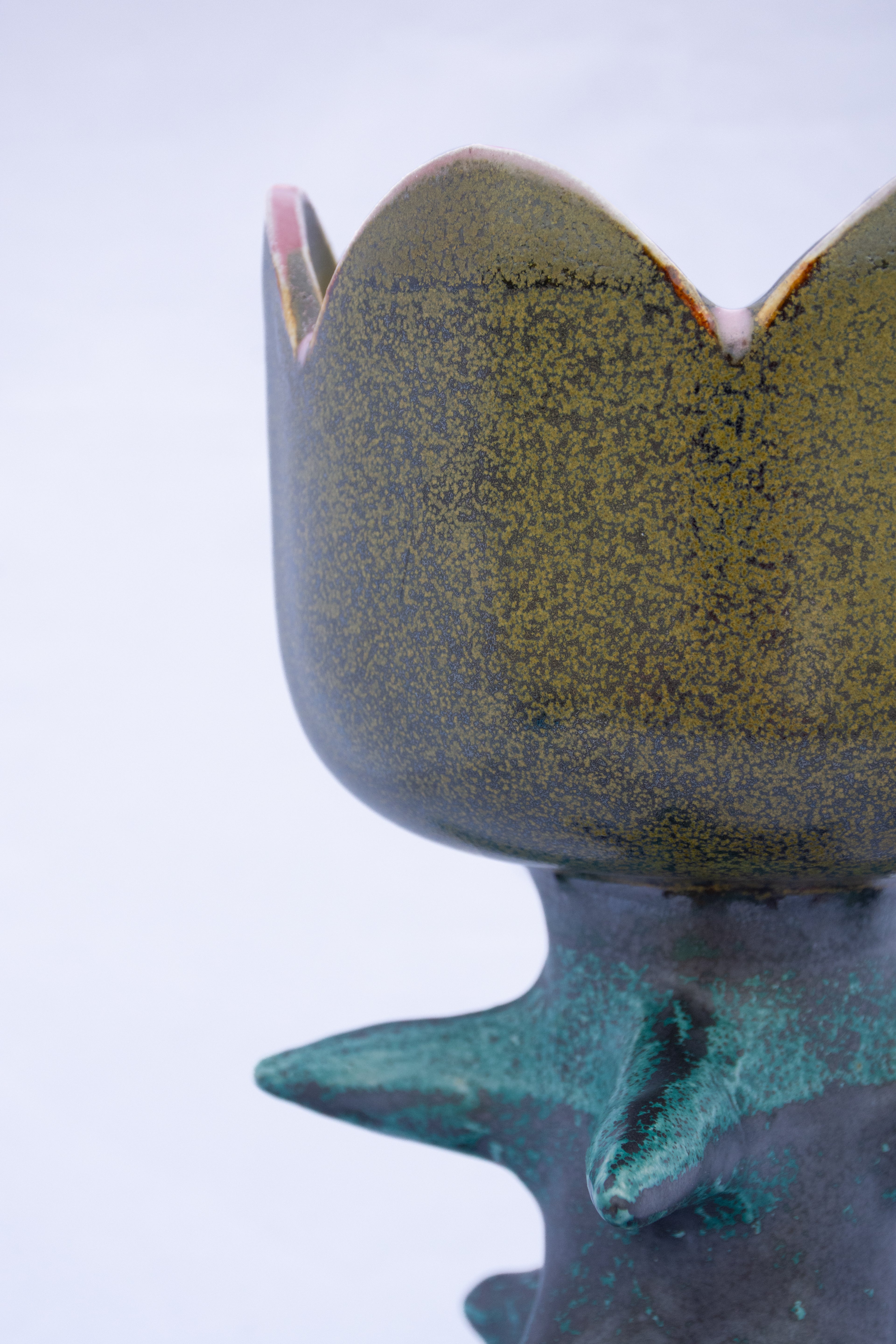 Ceramic lamp with textured surface on a light gray background